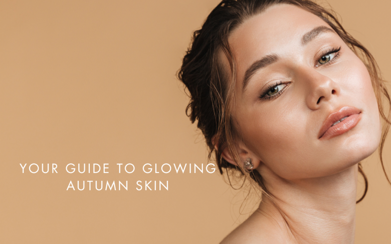 a model with glowing skin on a dark orange background. Your guide to glowing autumn skin.