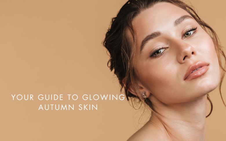 a model with glowing skin on a dark orange background. Your guide to glowing autumn skin. 